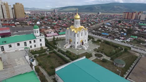 Aerial-drone-shot-of-a-russian-church-with-gold-plated-roof-in-mongolia